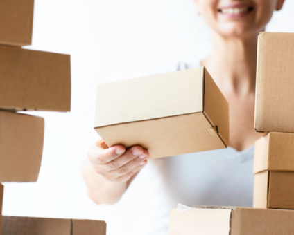 Woman stacking commerce boxes