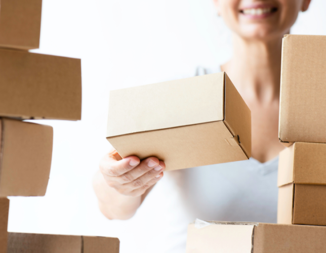 Woman stacking commerce boxes