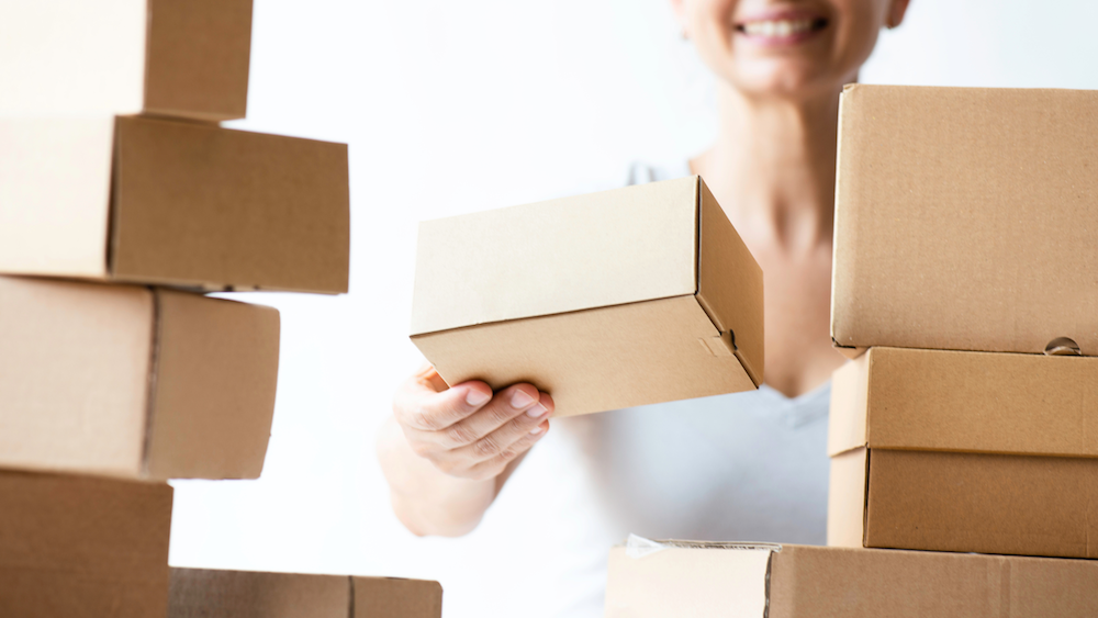 Woman stacking commerce boxes